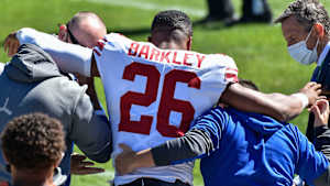 New York Giants running back Saquon Barkley (26) is helped off of the field after suffering an injury during the second quarter against the Chicago Bears at Soldier Field.